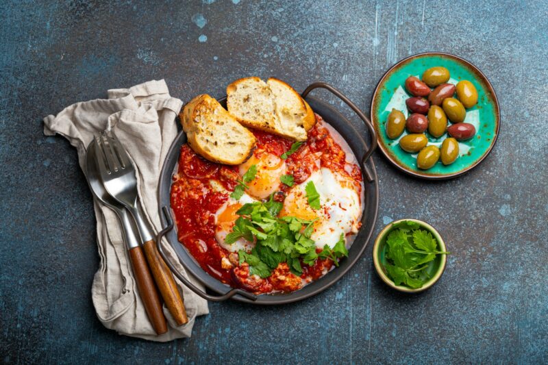 Middle Eastern and Maghrebi healthy dish Shakshouka made of eggs and tomato sauce served in pan