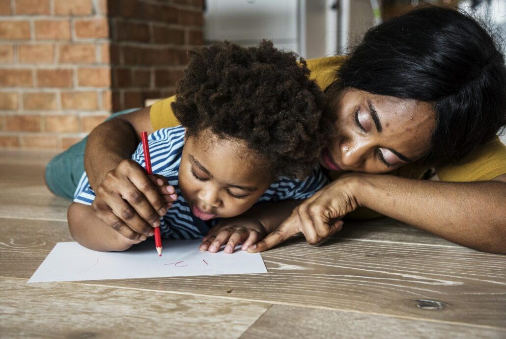 Mom teaching son how to drawing