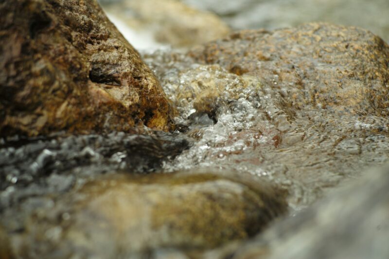 Motion blurred of water flows on the stone in the stream