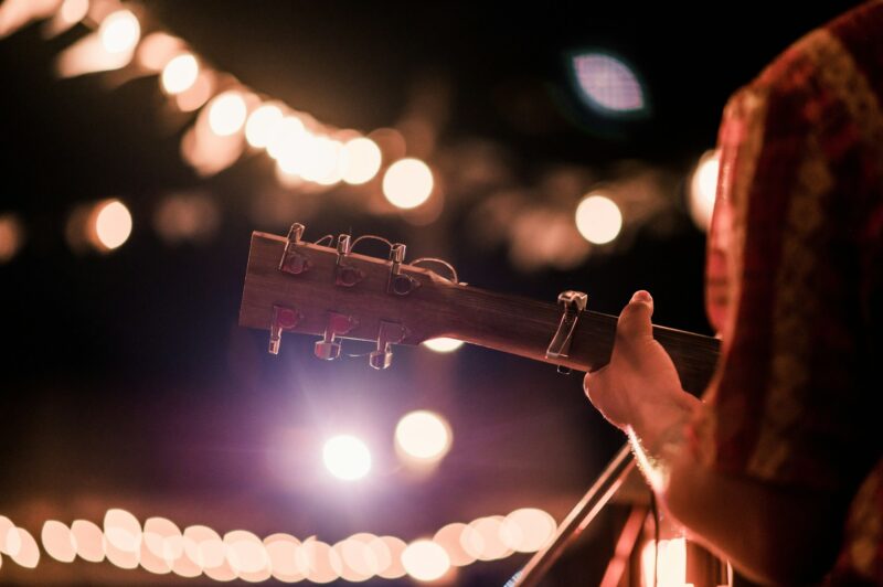 Musicians playing guitar at music festivals, lights, music, concerts, mini concerts. music festivals