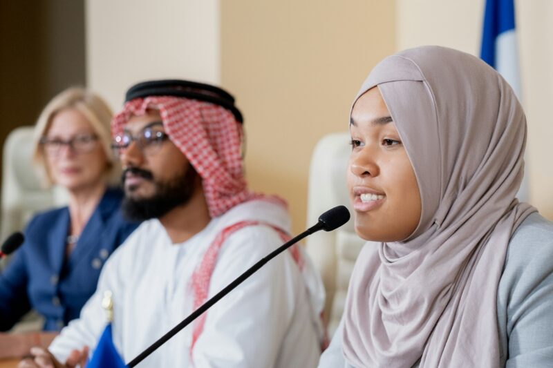 Muslim Woman Participating In Conference Discussion