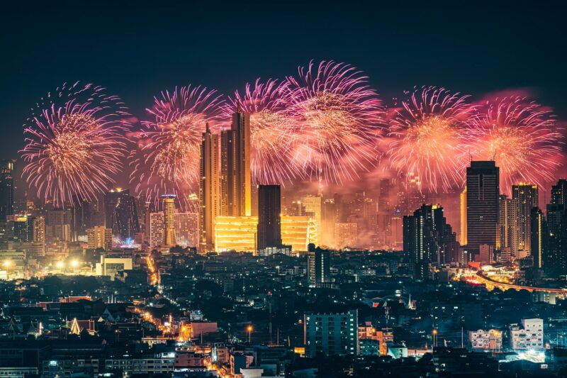 New year festival with firework display glowing over department store