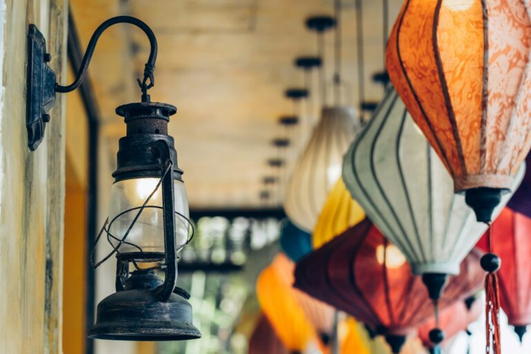 Old-fashion lantern glow softly juxtaposed with vibrant colorful fabric lanterns
