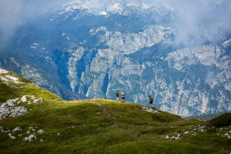 People are scaling the rocky terrain of a mountain in Triglav National Park