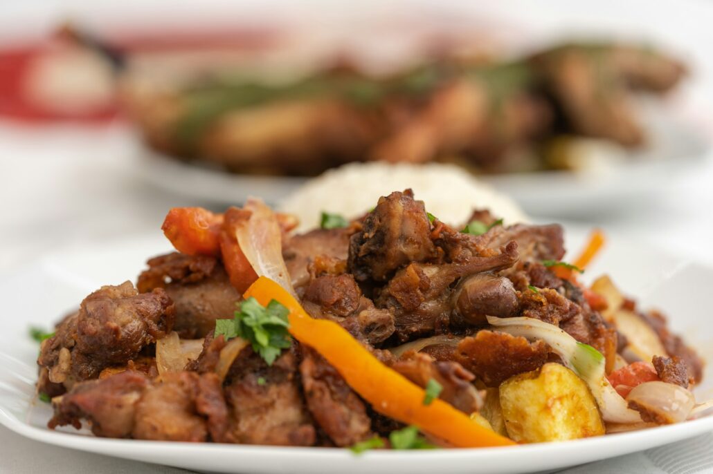 Plate of stew of guinea pig meat on a table