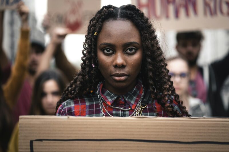 Portrait of African protest marcher with placard