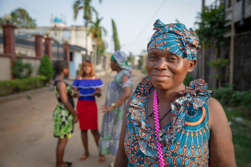 Portrait of an isolated African lady with three women talking in the background, African women