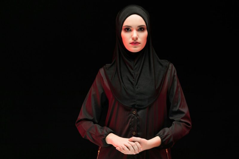 Portrait of beautiful arrogant young muslim woman wearing black hijab as conservative fashion