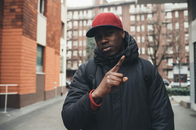 portrait of young african man standing in the street gesture