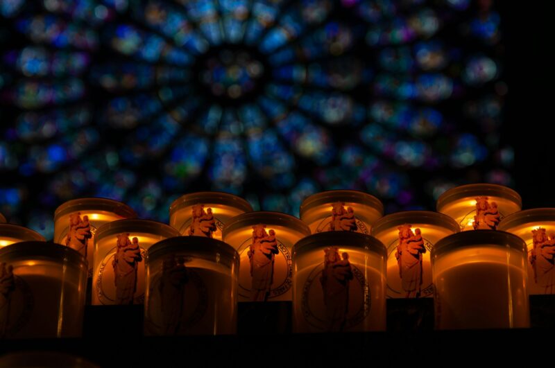 Prayer candles inside a traditional church, with an atmosphere of introspection and faith.