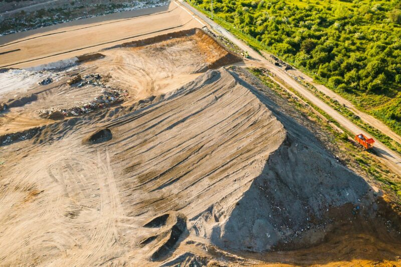 Quarry for mining of natural resources on the hill close to forest