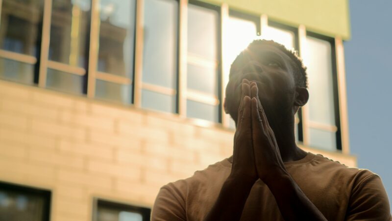 Religion concept African American man praying God for help prayer guy begging blessing in city male