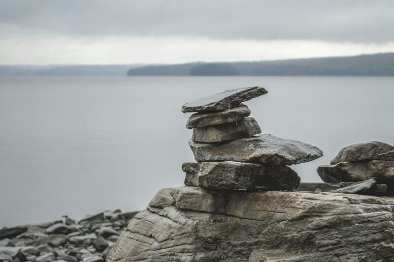 Rock cairn on the shore of a lake