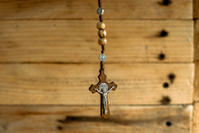 Rosary with wooden beads and Christian cross.