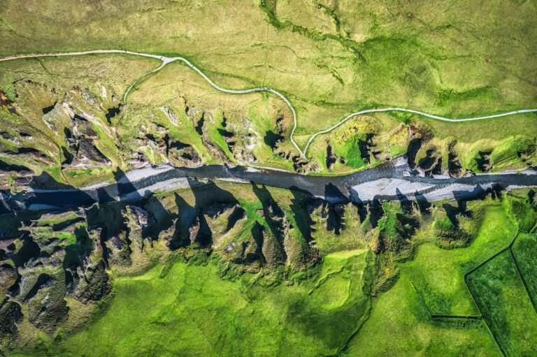 Rugged Fjadrargljufur canyon naturally eroded with river flowing in summer at Iceland