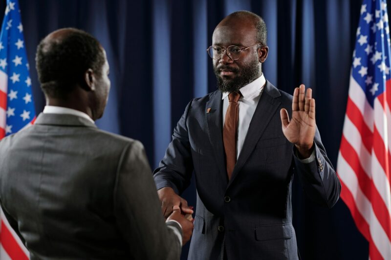 Serious young African American male president pronouncing oath of office