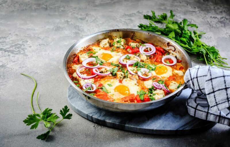 Shakshouka - poached eggs in sauce of tomatoes, peppers, onion and feta cheese.
