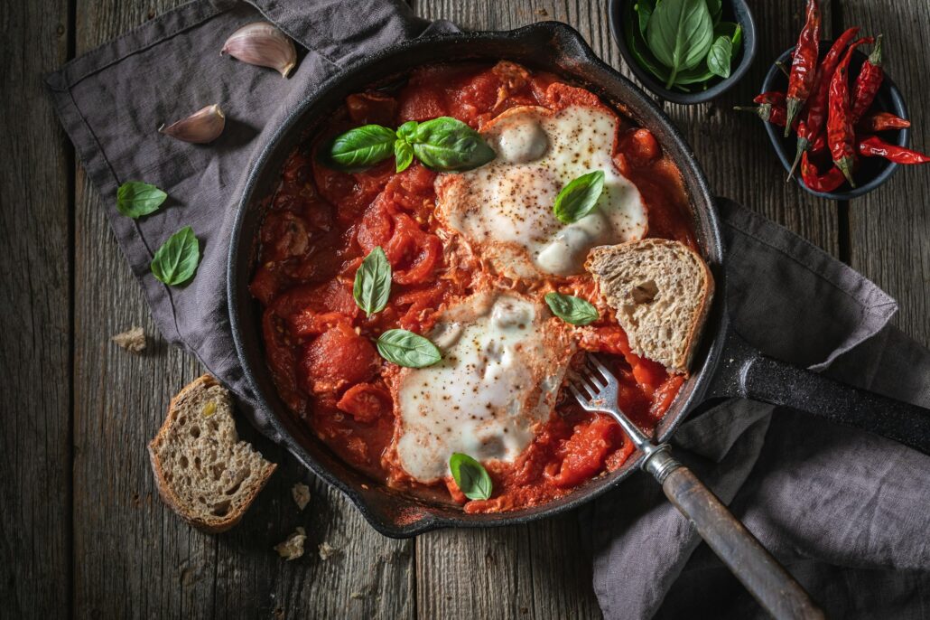 Shakshuka served with bread for breakfast. Tunisian cuisine.