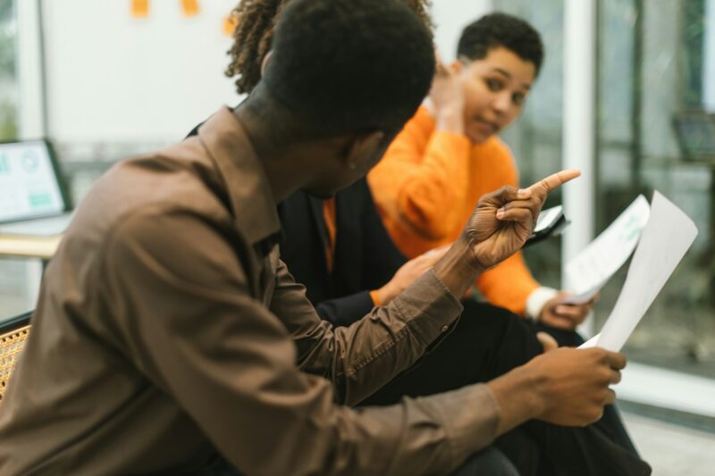 sitting African American colleagues brainstorming together for their startup