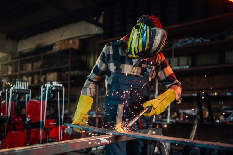 Skilled welder assembling durable pipelines for infrastructure project