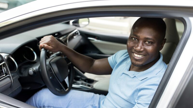 Smiling african american man sitting in auto