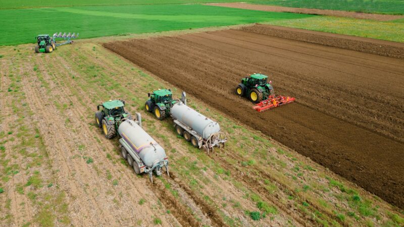 The coordinated work of these four tractors is a testament to the farming industry's ingenuity in
