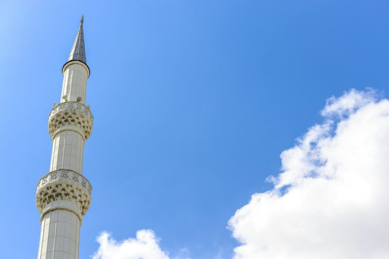 The minaret on a background of blue sky. Close up.