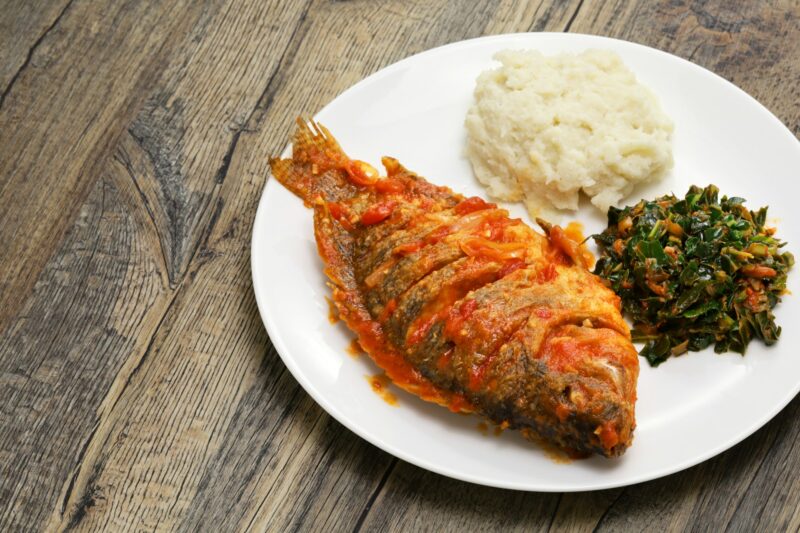 Tilapia stew, ugali(white maize flour mash) and Sukuma Wiki(kale stew), Kenyan food