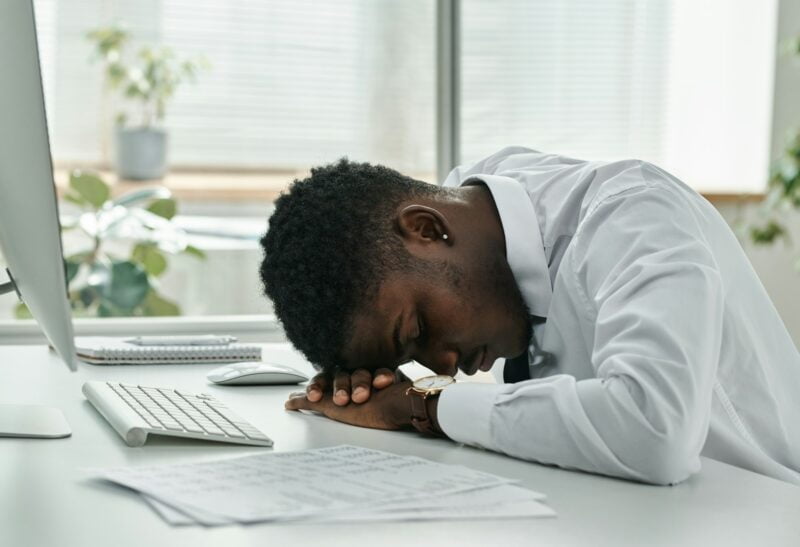 Tired businessman sleeping at workplace