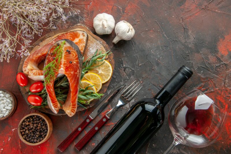 top view fresh fish slices with tomatoes and lemon slices on dark background dish color meat seafood