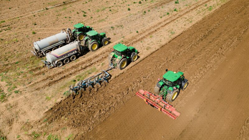 Tractors working seamlessly in unison exemplifies the spirit of rural life, where farm equipment and