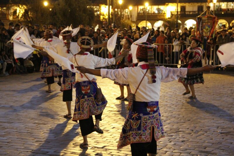 Traditional dances in the main square of Cusco at night, photo detail to the dancers