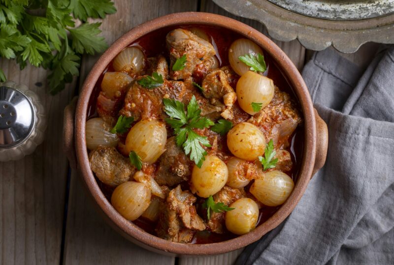 Traditional Greek dish of beef stifado in a sauce.