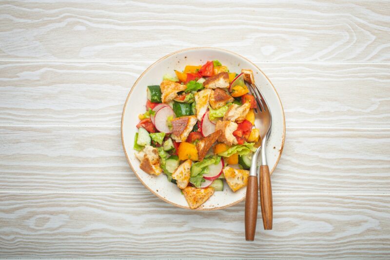 Traditional Levant dish Fattoush salad, Arab cuisine, with pita bread croutons, vegetables, herbs