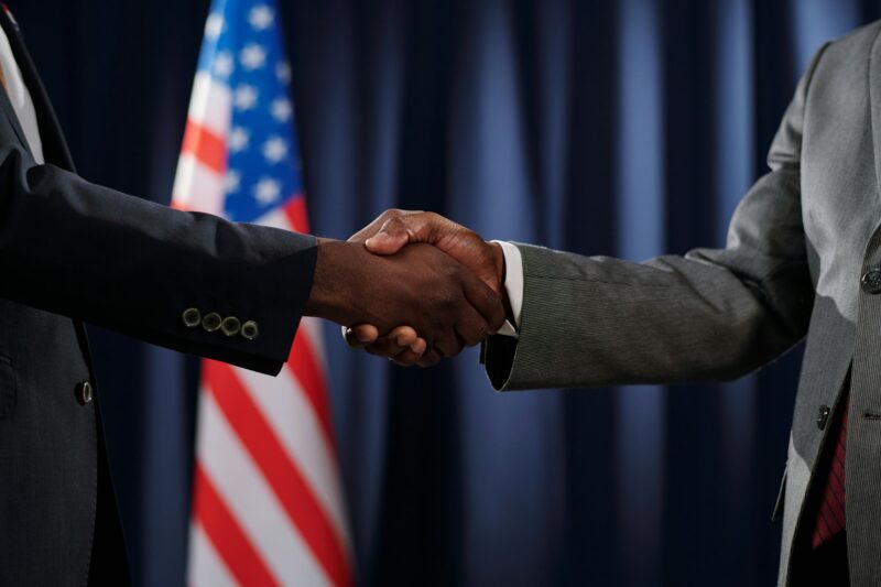 Two African American male delegates or political leaders shaking hands
