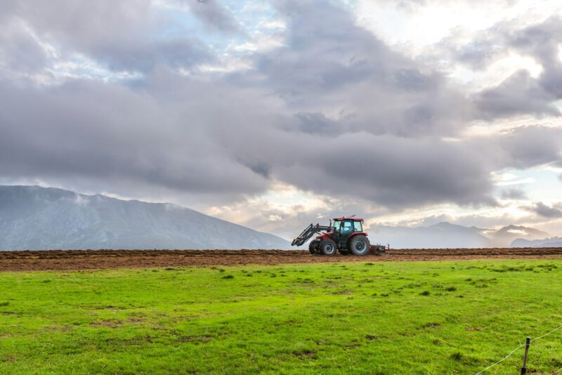 unrecognizable person performs agricultural work