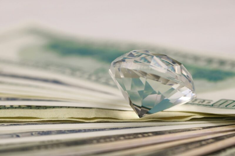 US money bills with large diamond close up