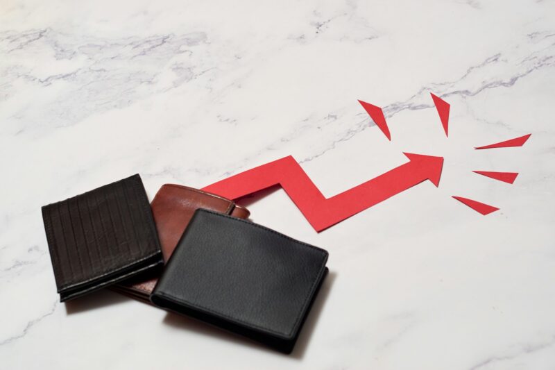 Wallet with crescent arrow. Concept of inflation and economic crisis, rising prices.