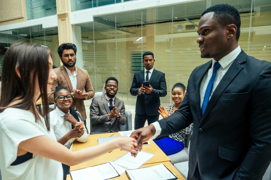 well-dressed business afro american men making a report to subordinate employees in a modern office