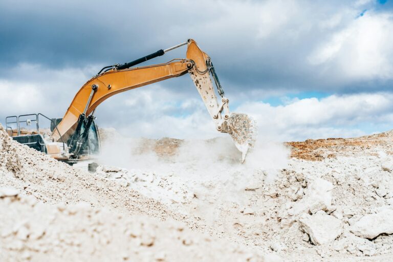 Wheel loader, large bucket with limestone. Construction. Open pit mining quarry