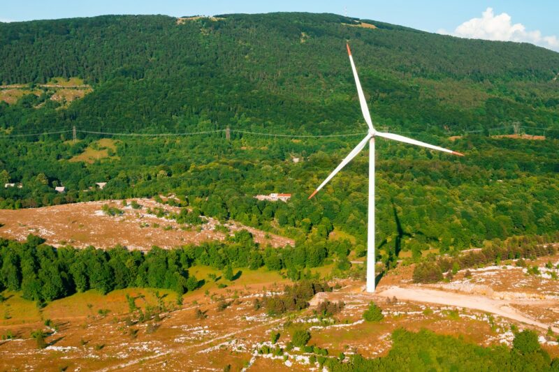 Wind driven generator operates against big forestry mountain