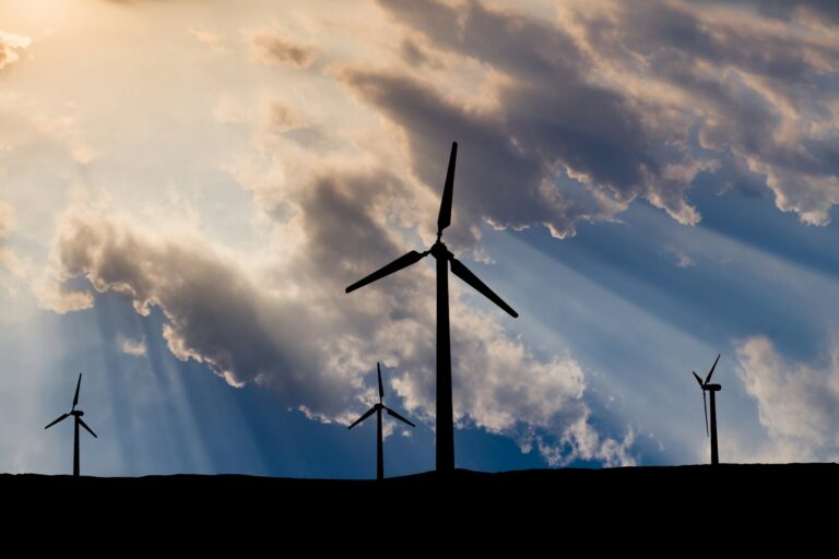 Wind turbines on the sunset sky background