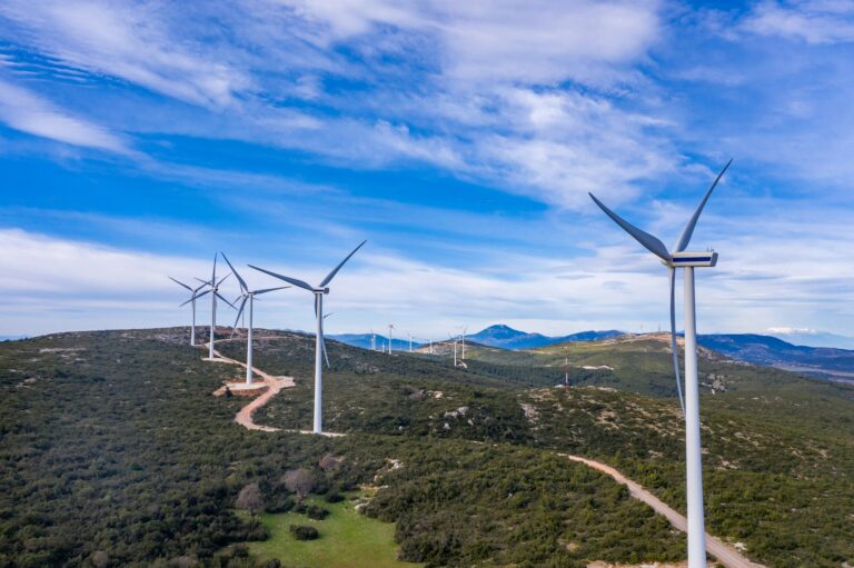 Wind turbines, renewable energy on a green hill. Wind farm