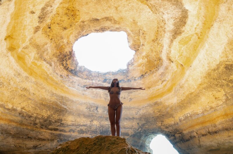woman standing in Benagil cave