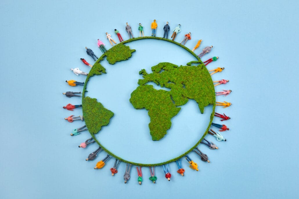 World Population Day, creative concept. Large and diverse group of people in the shape of the world
