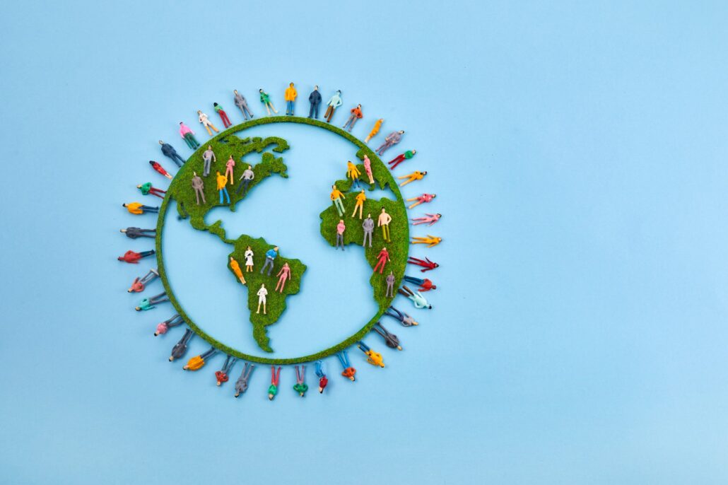 World Population Day, creative concept. Large and diverse group of people in the shape of the world