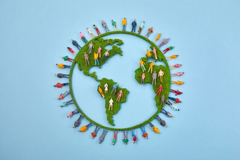 World Population Day, creative concept. Large and diverse group of people in the shape of the world