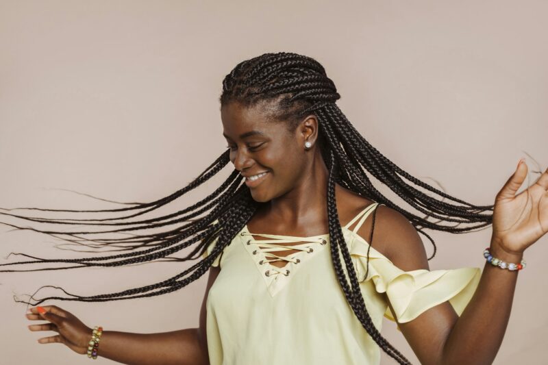 Young african woman dancing with braids at studio