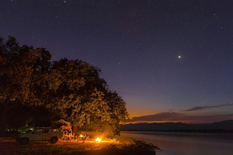 Zimbabwe, Urungwe District, Mana Pools National Park, camp fire at riverside of Zambezi at night