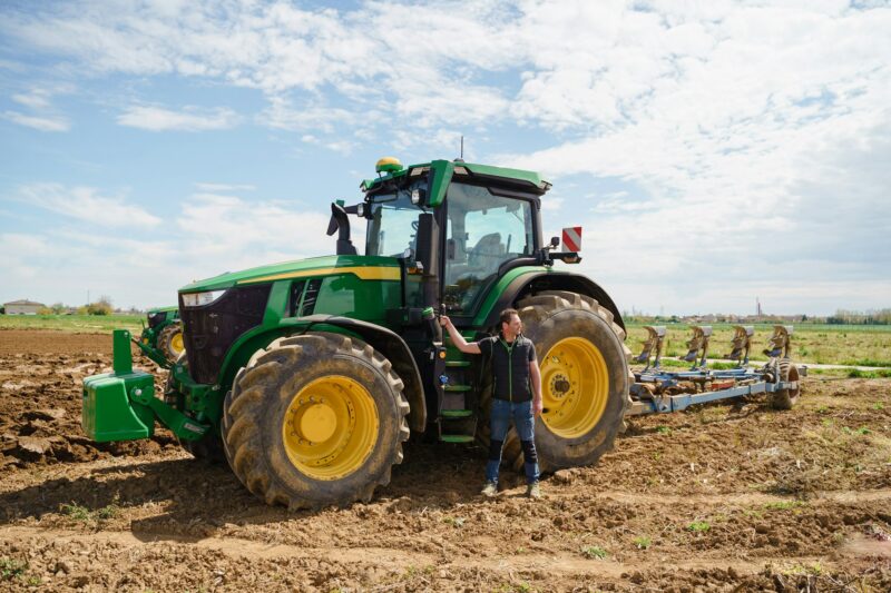 A farmer using a tractor to prepare the fields for planting. The image highlights the importance of